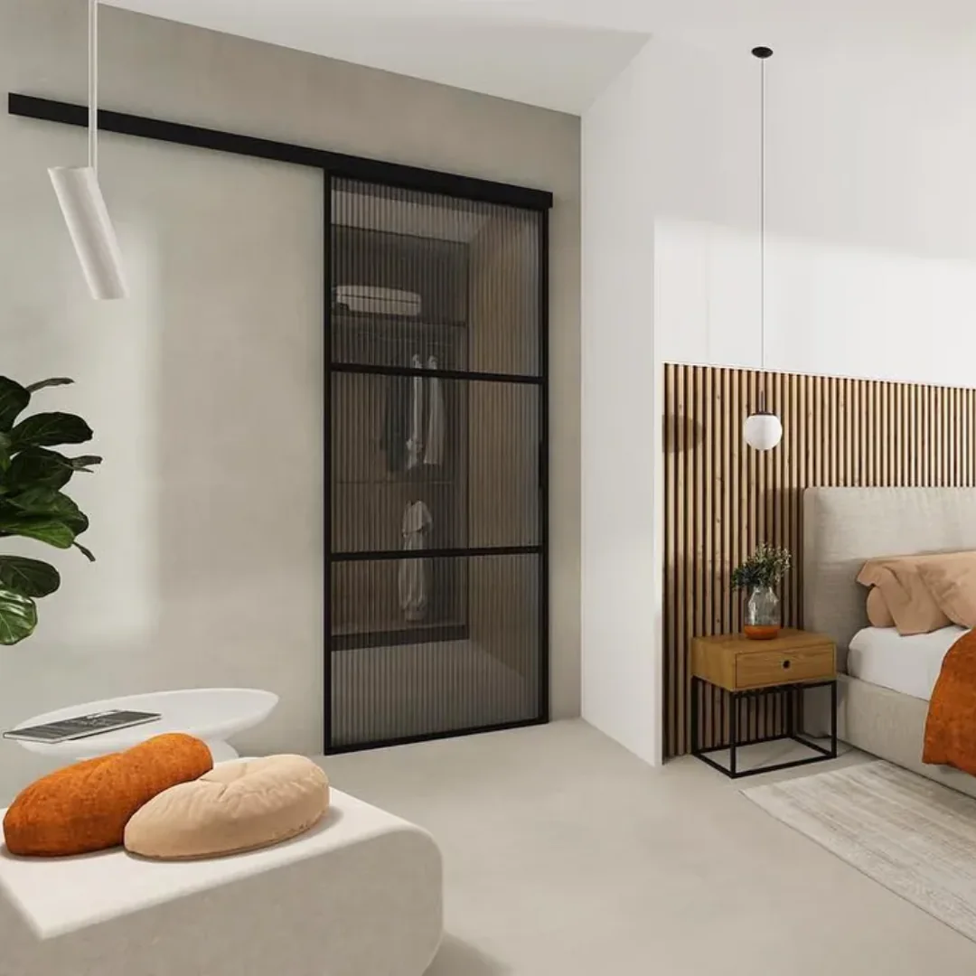 Black sliding loft door with fluted glass in a bedroom